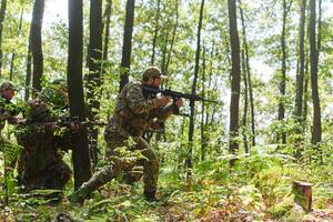 A disciplined and specialized military unit, donned in camouflage, strategically patrolling and maintaining control in a high-stakes environment, showcasing their precision, unity, and readiness for photo