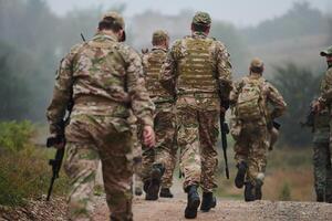 A disciplined and specialized military unit, donned in camouflage, strategically patrolling and maintaining control in a high-stakes environment, showcasing their precision, unity, and readiness for photo