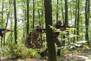 A specialized military antiterrorist unit conducts a covert operation in dense, hazardous woodland, demonstrating precision, discipline, and strategic readiness photo