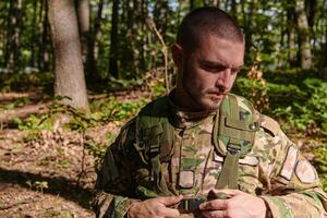 Elite soldier exudes focused determination and readiness, geared up for a perilous military operation, capturing the essence of courage and professionalism in the face of imminent danger photo
