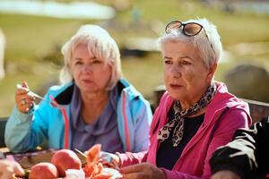 A family on a mountain vacation indulges in the pleasures of a healthy life, savoring traditional pie while surrounded by the breathtaking beauty of nature, fostering family bonds and embracing the photo