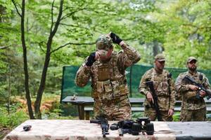 An elite military unit prepares for a hazardous forest operation, showcasing tactical prowess, camouflage skills, and strategic readiness photo