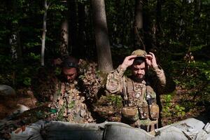 two elite soldiers meticulously prepare for a dangerous military operation, embodying strategic readiness, discipline, and teamwork as they gear up for a mission fraught with intensity and peril. photo