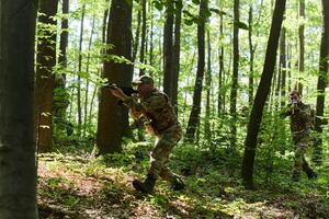 A specialized military antiterrorist unit conducts a covert operation in dense, hazardous woodland, demonstrating precision, discipline, and strategic readiness photo