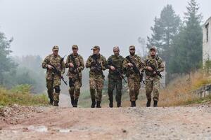 A disciplined and specialized military unit, donned in camouflage, strategically patrolling and maintaining control in a high-stakes environment, showcasing their precision, unity, and readiness for photo