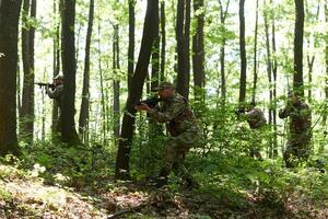 A specialized military antiterrorist unit conducts a covert operation in dense, hazardous woodland, demonstrating precision, discipline, and strategic readiness photo