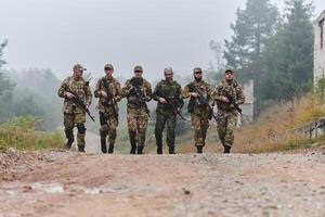 A disciplined and specialized military unit, donned in camouflage, strategically patrolling and maintaining control in a high-stakes environment, showcasing their precision, unity, and readiness for photo