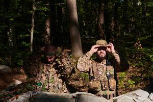 two elite soldiers meticulously prepare for a dangerous military operation, embodying strategic readiness, discipline, and teamwork as they gear up for a mission fraught with intensity and peril. photo
