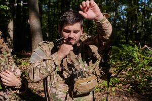 Elite soldier exudes focused determination and readiness, geared up for a perilous military operation, capturing the essence of courage and professionalism in the face of imminent danger photo