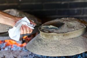 Capturing the essence of Bosnian culinary tradition, step-by-step preparation of a traditional Bosnian pie, showcasing the meticulous craftsmanship and authentic flavors involved in the culinary photo