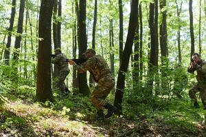 A specialized military antiterrorist unit conducts a covert operation in dense, hazardous woodland, demonstrating precision, discipline, and strategic readiness photo