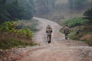 A disciplined and specialized military unit, donned in camouflage, strategically patrolling and maintaining control in a high-stakes environment, showcasing their precision, unity, and readiness for photo