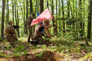 A disciplined and specialized military unit, donned in camouflage, strategically patrolling and maintaining control in a high-stakes environment, showcasing their precision, unity, and readiness for photo