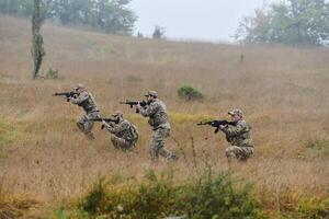 A disciplined and specialized military unit, donned in camouflage, strategically patrolling and maintaining control in a high-stakes environment, showcasing their precision, unity, and readiness for photo