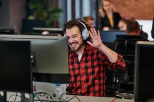 Joyful Collaboration. A Man Embracing Remote Work with Enthusiastic Gestures in a Coworking Space. photo
