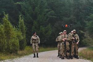 An elite military unit, led by a major, confidently parades through dense forest, showcasing precision, discipline, and readiness for high-risk operations photo
