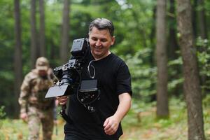 A videographer captures the intensity of a perilous military operation, documenting soldiers in action amidst the dense forest, showcasing the hazardous conditions and tactical maneuvers undertaken by photo