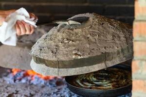 Capturing the essence of Bosnian culinary tradition, step-by-step preparation of a traditional Bosnian pie, showcasing the meticulous craftsmanship and authentic flavors involved in the culinary photo