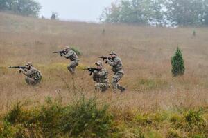A disciplined and specialized military unit, donned in camouflage, strategically patrolling and maintaining control in a high-stakes environment, showcasing their precision, unity, and readiness for photo
