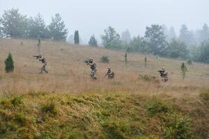 A disciplined and specialized military unit, donned in camouflage, strategically patrolling and maintaining control in a high-stakes environment, showcasing their precision, unity, and readiness for photo