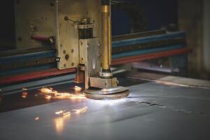 Plasma cutting of metal.The machine cuts iron with sparks.Industrial manufacture of products from iron sheets photo