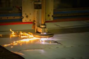Plasma cutting of metal.The machine cuts iron with sparks.Industrial manufacture of products from iron sheets photo