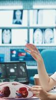 Vertical Female doctor and patient engage in a medical consultation for a scan interpretation of x ray results. Physician specialist emphasizing modern healthcare practices and medical research. Camera B. video
