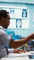 Vertical Physician doing a medical consultation with blood pressure monitor, taking pulse and heartbeat measurements for cardiac readings. Providing high quality control and healthcare services. Camera B. video