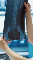Vertical General practitioner consults patient about diagnostic test results, utilizing medical technology for analysis and patient care management in a clinical environment. Healthcare provider. Camera A. video