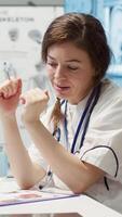 Vertical Healthcare professional sharing her medical expertise with a patient in office, reviewing x ray and MRI scans and focusing on accurate diagnostics and patient care. Diagnostic report. Camera A. video