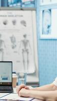 Vertical Physician entering a call with specialist to discuss diagnostic report, asking the expert for a second opinion on remote videoconference. Medics meeting online for telehealth. Camera A. video