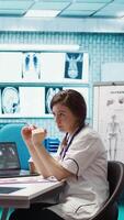 Vertical Healthcare professional sharing her medical expertise with a patient in office, reviewing x ray and MRI scans and focusing on accurate diagnostics and patient care. Diagnostic report. Camera B. video