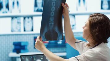 General practitioner consults patient about diagnostic test results, utilizing medical technology for analysis and patient care management in a clinical environment. Healthcare provider. Camera A. video