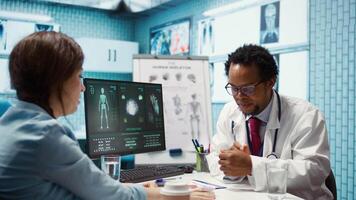 Medical expert taking oxygen saturation levels with an oximeter, doing measurements and vital signs readings with a digital device with clip. Doctor consulting a patient at appointment. Camera B. video
