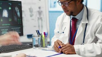Doctor highlighting dosage of vitamins and painkillers on medical prescription, explaining the instructions and in order to recovery quickly. Modern healthcare services. Camera A. video