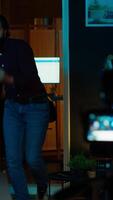 Vertical Content creator entering home studio, doing cool hand gesturing towards camera during live broadcast on online streaming platforms. Entertainer pointing fingers, captivating audience, camera A video