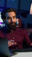 Vertical Man in studio reviewing gaming keyboard received from sponsoring brand. Online show host paid to promote bluetooth wireless computer peripheral to viewers during live broadcast, camera A video
