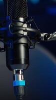 Vertical Close up shot of podcast microphone used to record internet show for online livestreaming channel. Streaming sound capturing and recording podcasting tool in empty living room with neon lights video