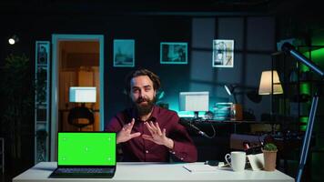 Entertainer presents chroma key laptop from brand sponsoring , analyzing features. Content creator reviewing green screen notebook for technology enthusiasts, inspecting materials, camera B video