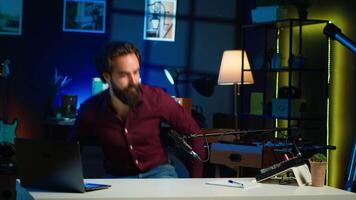 Man arriving in studio, filming sponsored content, holding empty copy space sign, following script, talking to audience. Internet star using cardboard bubble speech cutout to do marketing, camera A video