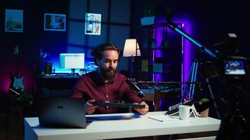 Content creator filming technology review of newly released DJ controller, unboxing it, excited to look at specifications. Influencer showcasing sound mixer device to viewers, camera B video