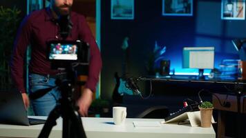 Happy internet star using professional recording equipment to film vlog channel intro for online streaming platforms, arriving in studio. Joyful man greets fans, presenting today topic, camera A video