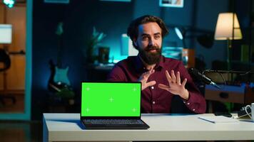 Entertainer presents chroma key laptop from brand sponsoring , analyzing features. Content creator reviewing green screen notebook for technology enthusiasts, inspecting materials, camera A video