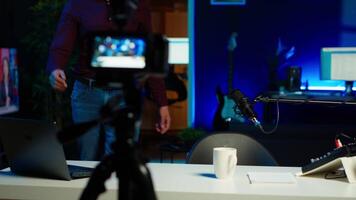 Influencer entering home studio, doing live broadcast for online streaming platforms, talking with fans, sharing story. Media star telling viewers about himself, camera A video