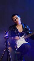 Vertical Punk rock musician hosting a live event concert on online streaming session, singing heavy metal alternative music in the studio. Artist doing a digital performance on social media. Camera B. video