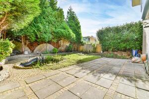 A backyard with a patio and a garden photo