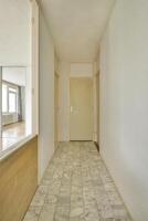 A hallway with a door and a mirror photo