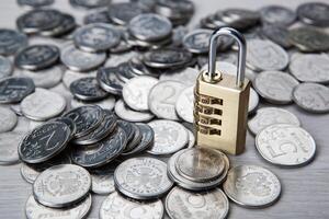 brass padlock with code and russian ruble coins photo