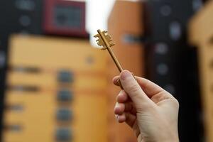 hand holds the keys against the background of new buildings photo