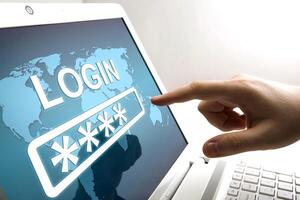 human fingers on the notebook screen with login and network authorization photo